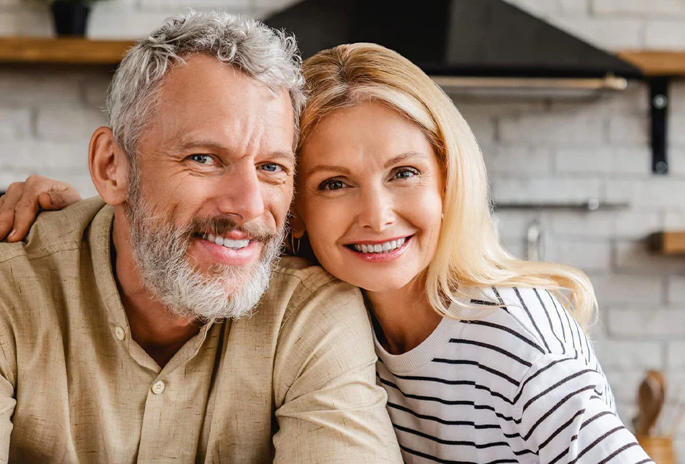 Senior couple with dental implants feeling great