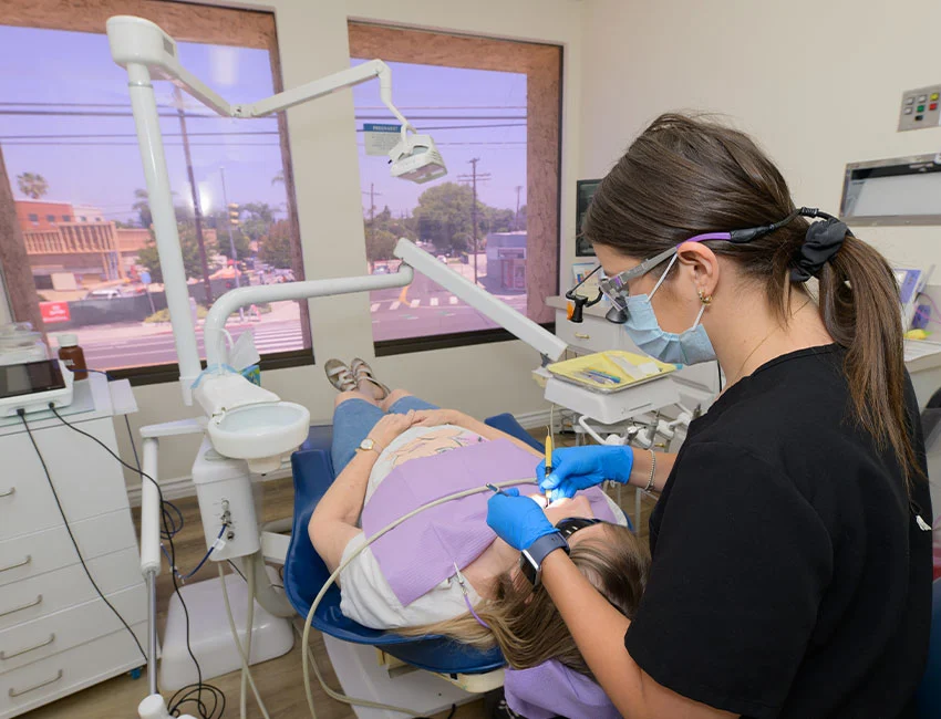 Female Dentist working on patients teeth